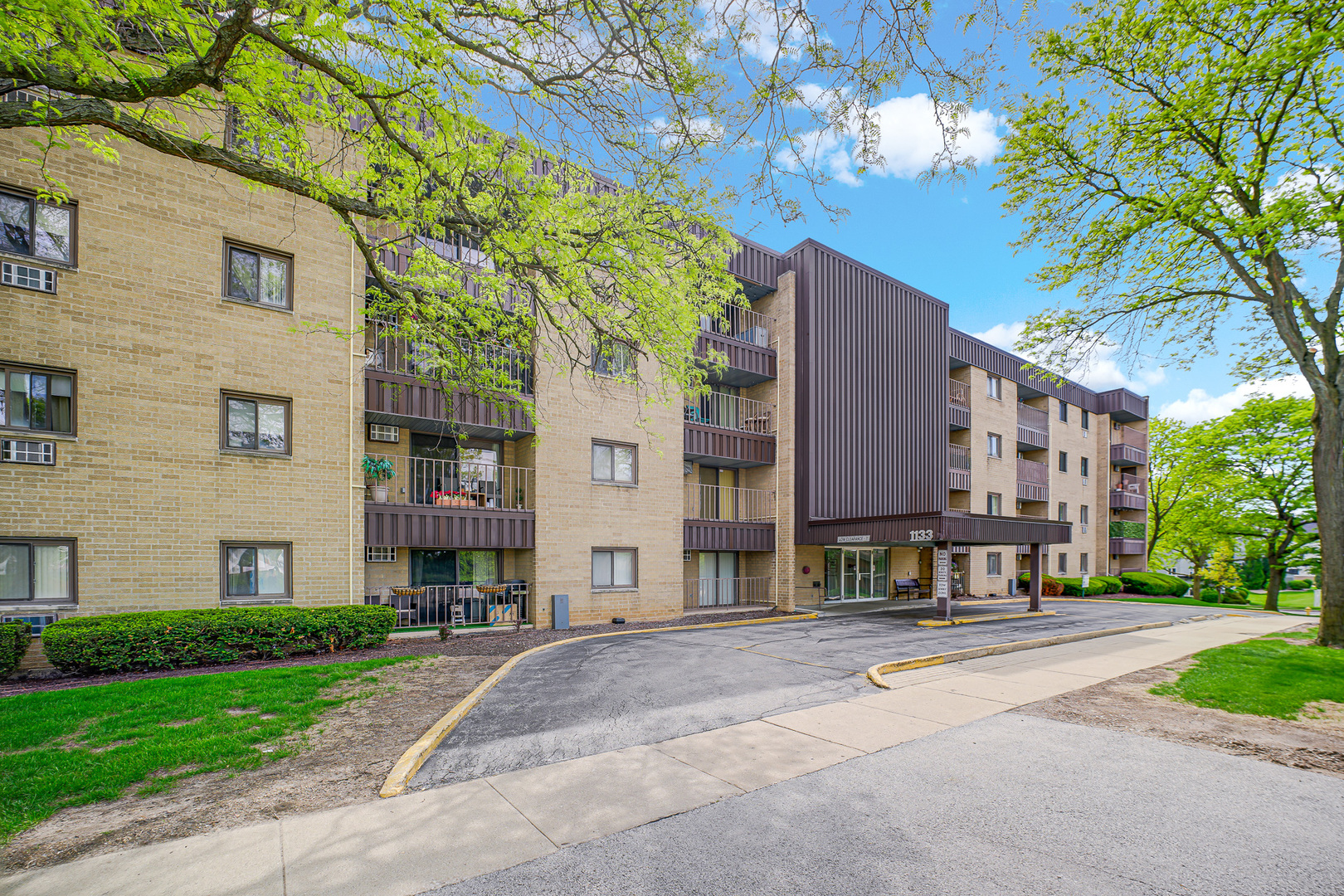 1133 South Finley Road, Unit 310 Lombard, IL 60148 - Photo 3 of 29 a building with a tree in front of it