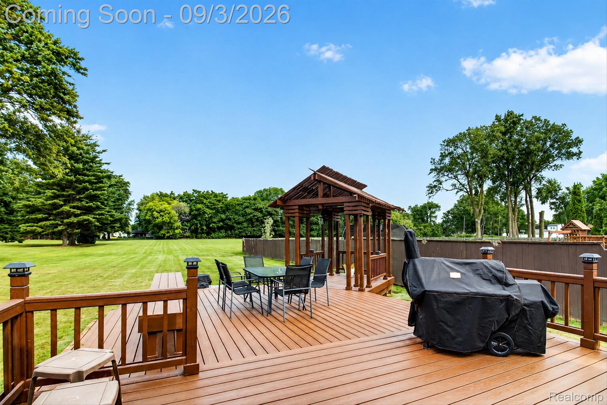 27260 Campbell Road Warren, MI 48093 - Photo 53 of 60 Expansive wood-finish deck with integrated railing and post cap lighting