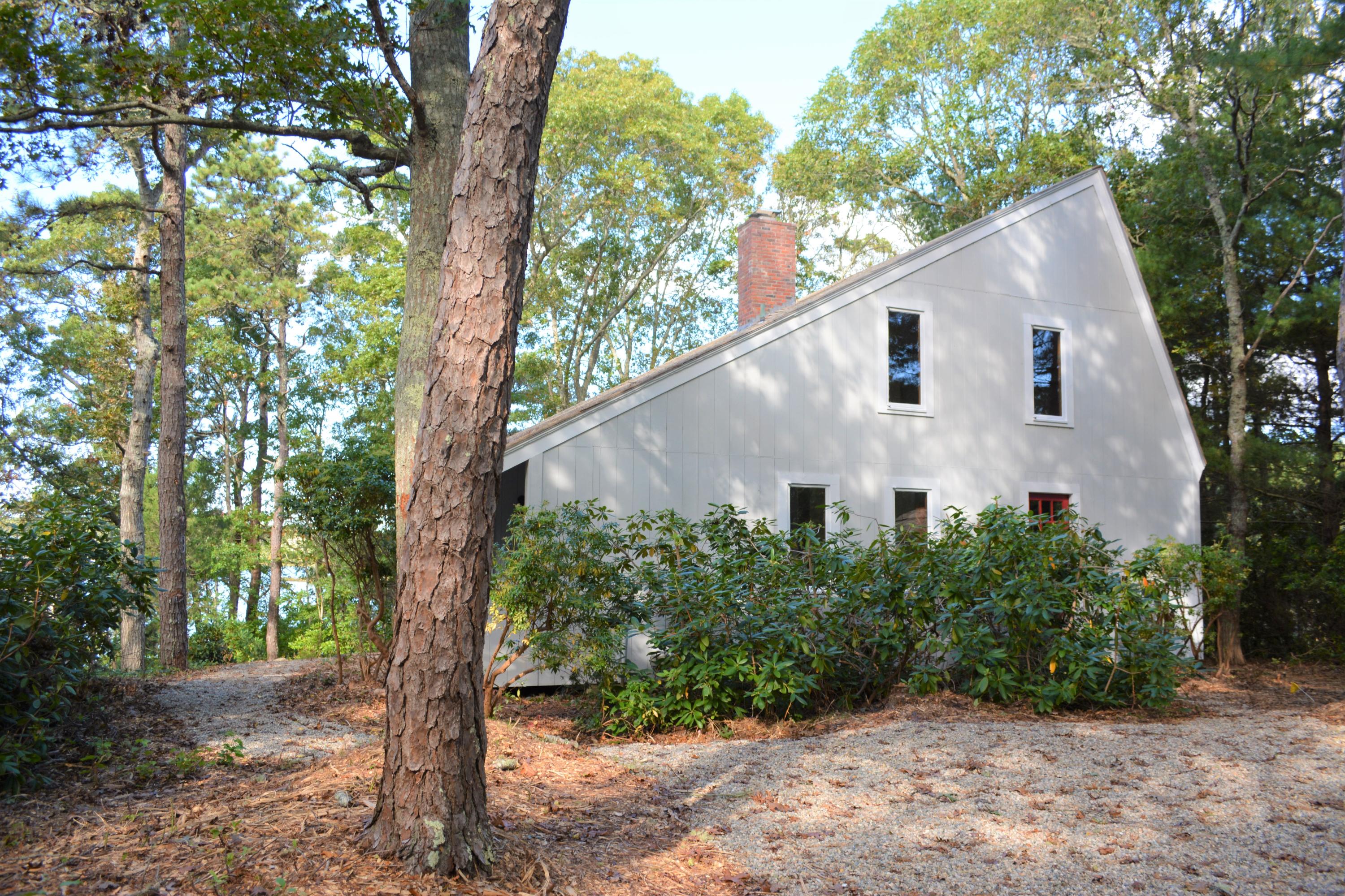 76 Summersea Road Mashpee, MA 02649 - Photo 23 of 24 a white house in middle of the forest