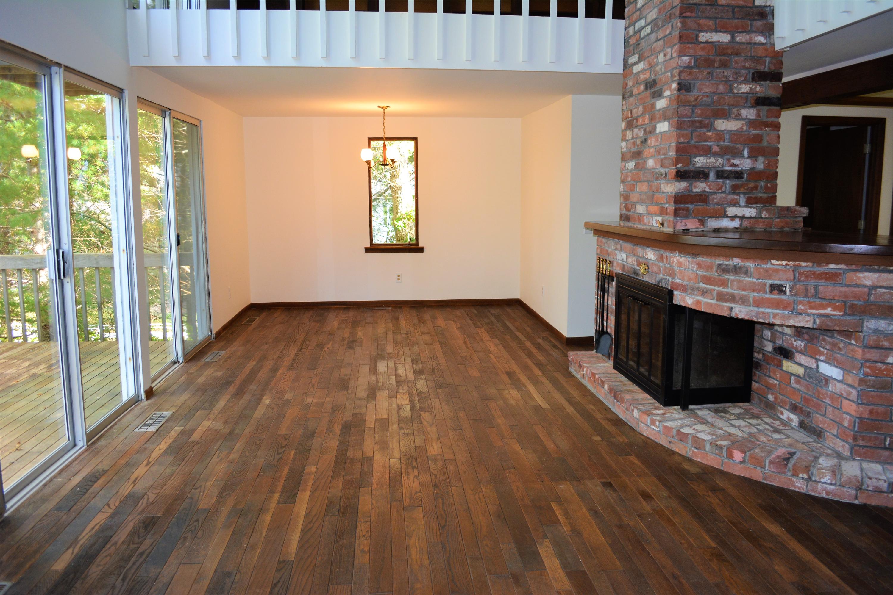 76 Summersea Road Mashpee, MA 02649 - Photo 4 of 24 a view of a livingroom with wooden floor a fireplace and windows