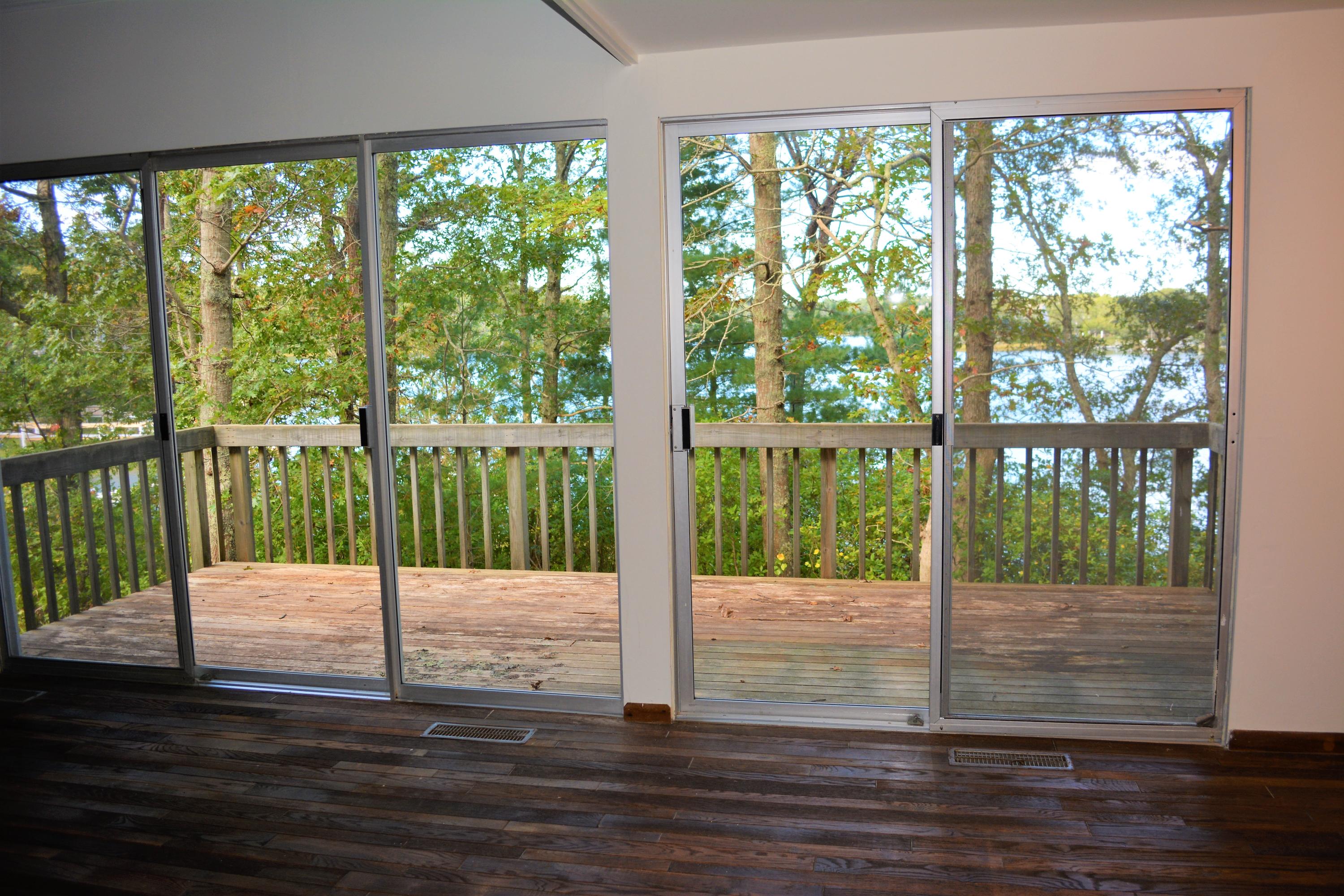 76 Summersea Road Mashpee, MA 02649 - Photo 5 of 24 a view of a room with wooden floor and a floor to ceiling window