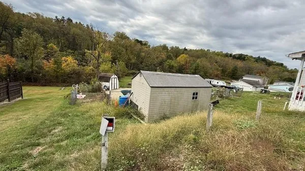 a patio with table and chairs and potted plants