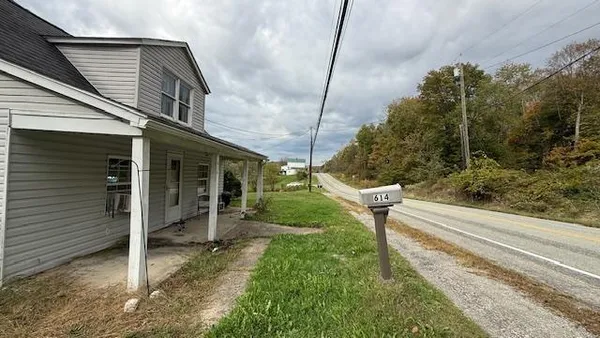 a view of a chair and tables in the house front of house