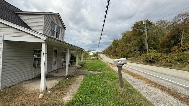 a view of a chair and tables in the house front of house