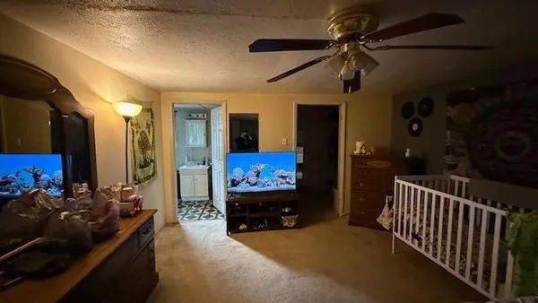 a view of living room kitchen and stainless steel appliances