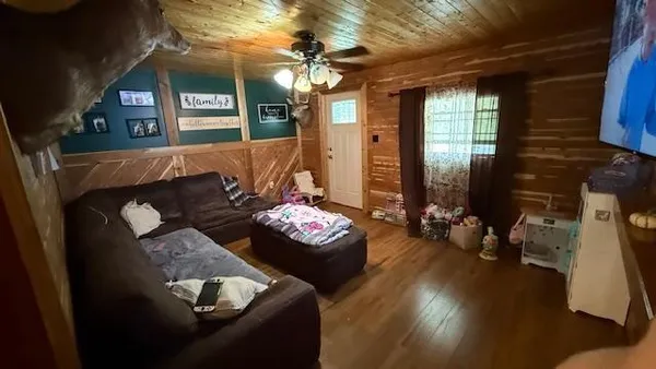 a living room with furniture and a chandelier