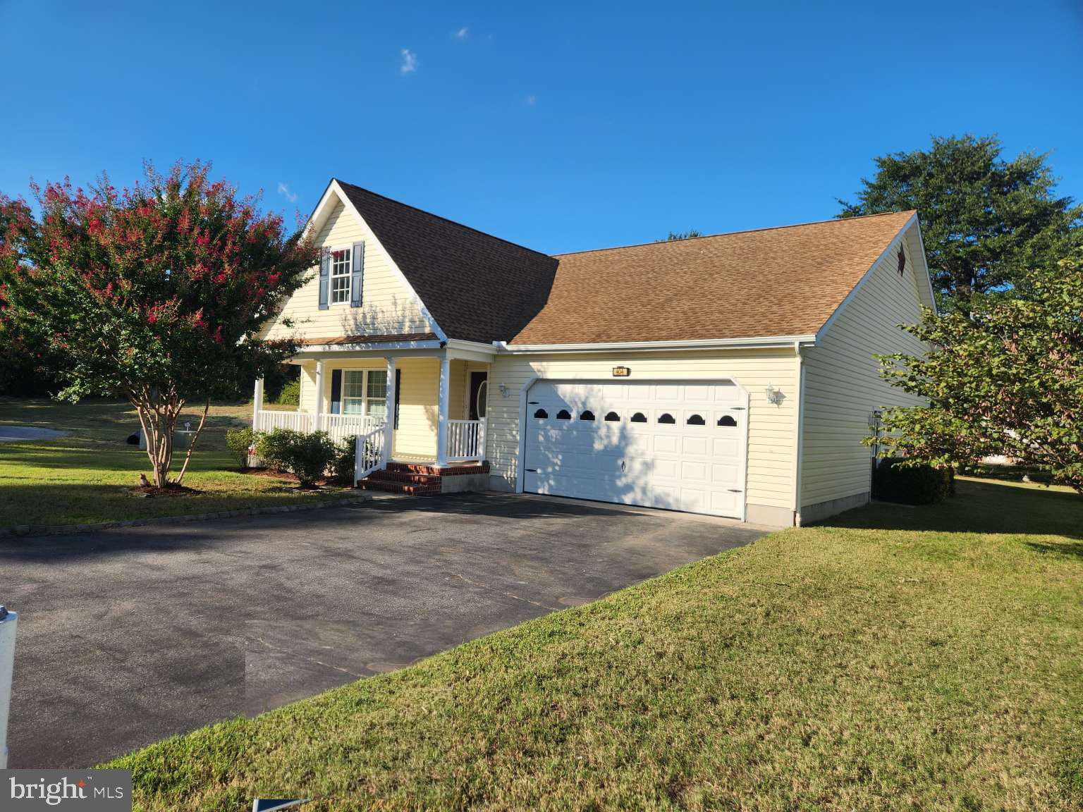 a view of a house with a yard and sitting area