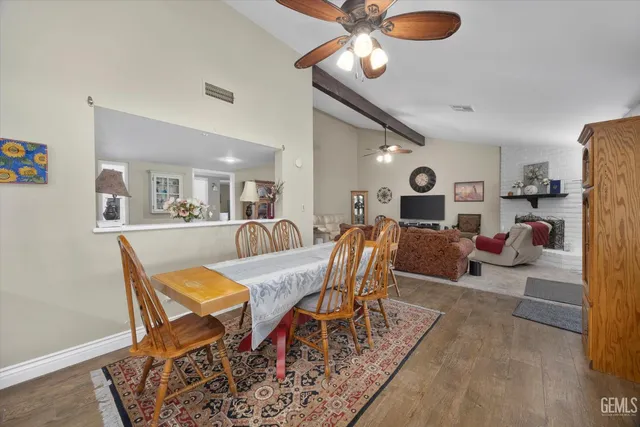 a living room with furniture kitchen view and a chandelier