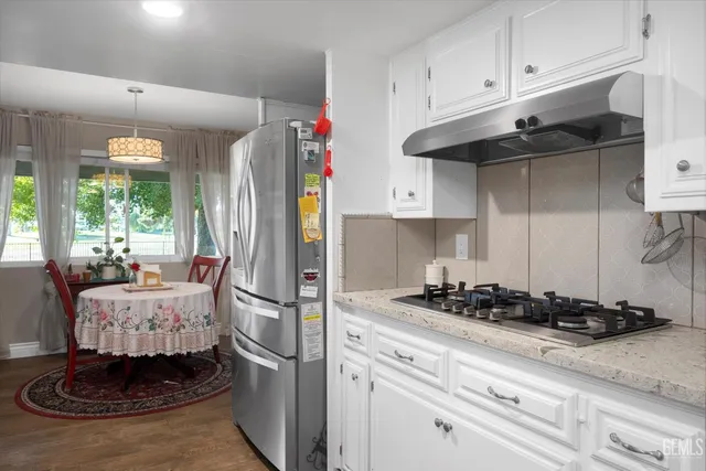 a kitchen with a refrigerator and cabinets