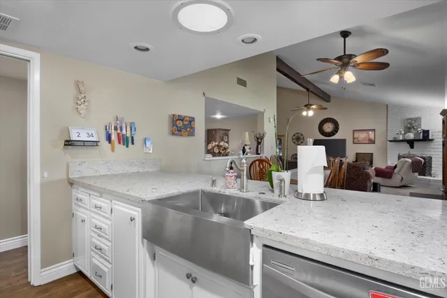a kitchen with a sink a counter space and stainless steel appliances
