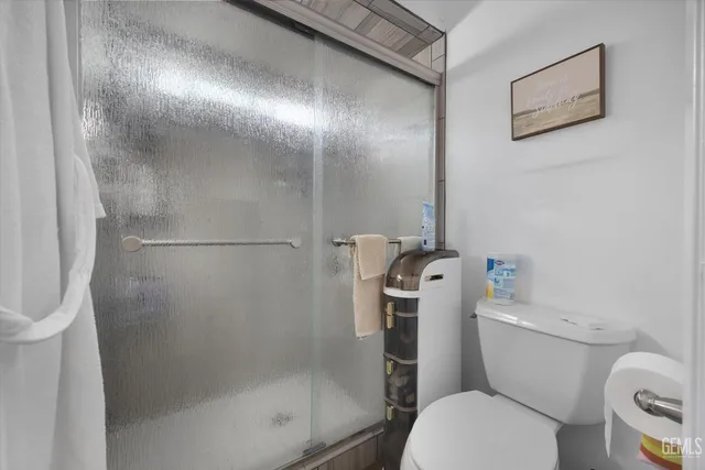 a white toilet sitting next to a bathroom sink