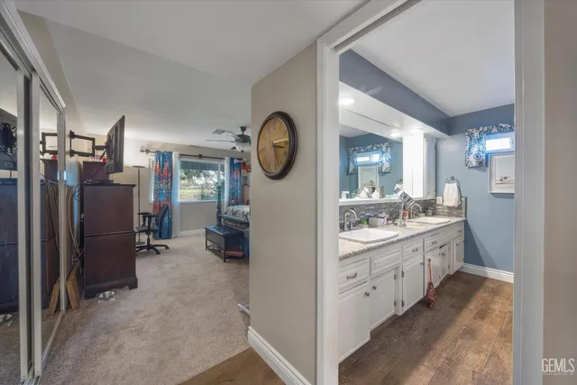 a large bathroom with a granite countertop double vanity sink and a mirror