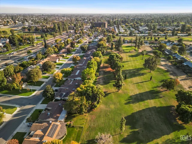 an aerial view of residential houses with outdoor space