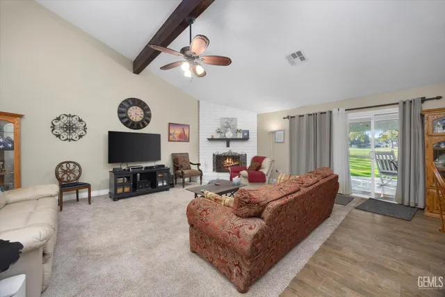 a living room with furniture a large window and a flat screen tv