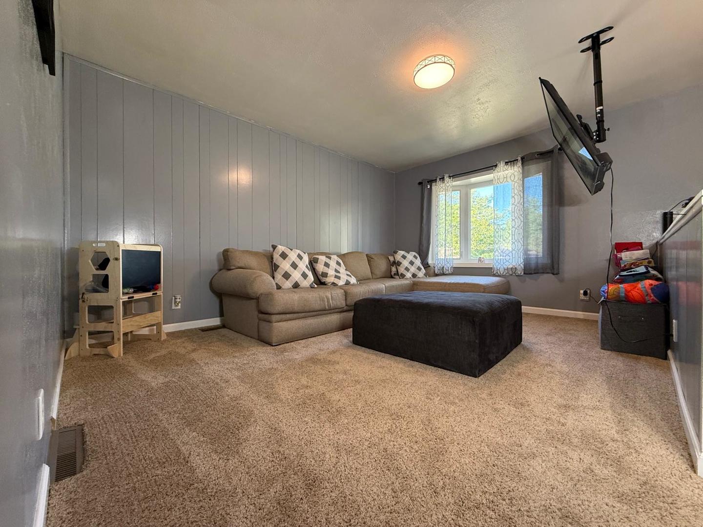 424 Rambler Place Streamwood, IL 60107 - Photo 2 of 10 a living room with furniture a window and a flat screen tv