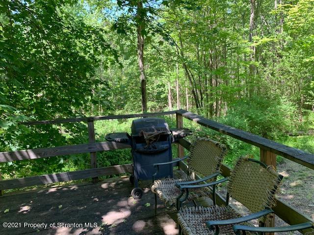 284 Carpenter Road Harveys Lake, PA 18612 - Photo 29 of 33 a view of a balcony with chairs and a potted plant