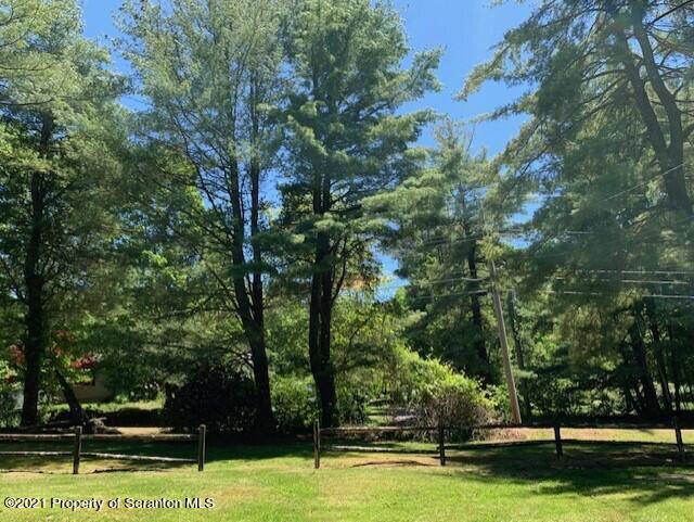 284 Carpenter Road Harveys Lake, PA 18612 - Photo 5 of 33 a view of a swimming pool with trees and sitting area