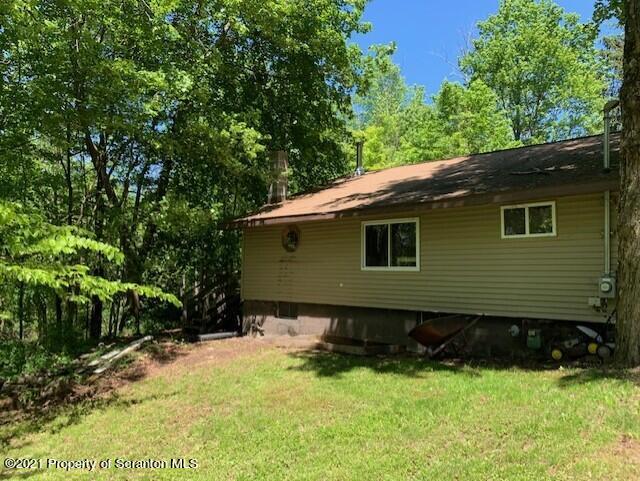 284 Carpenter Road Harveys Lake, PA 18612 - Photo 7 of 33 a side view of a house with a yard