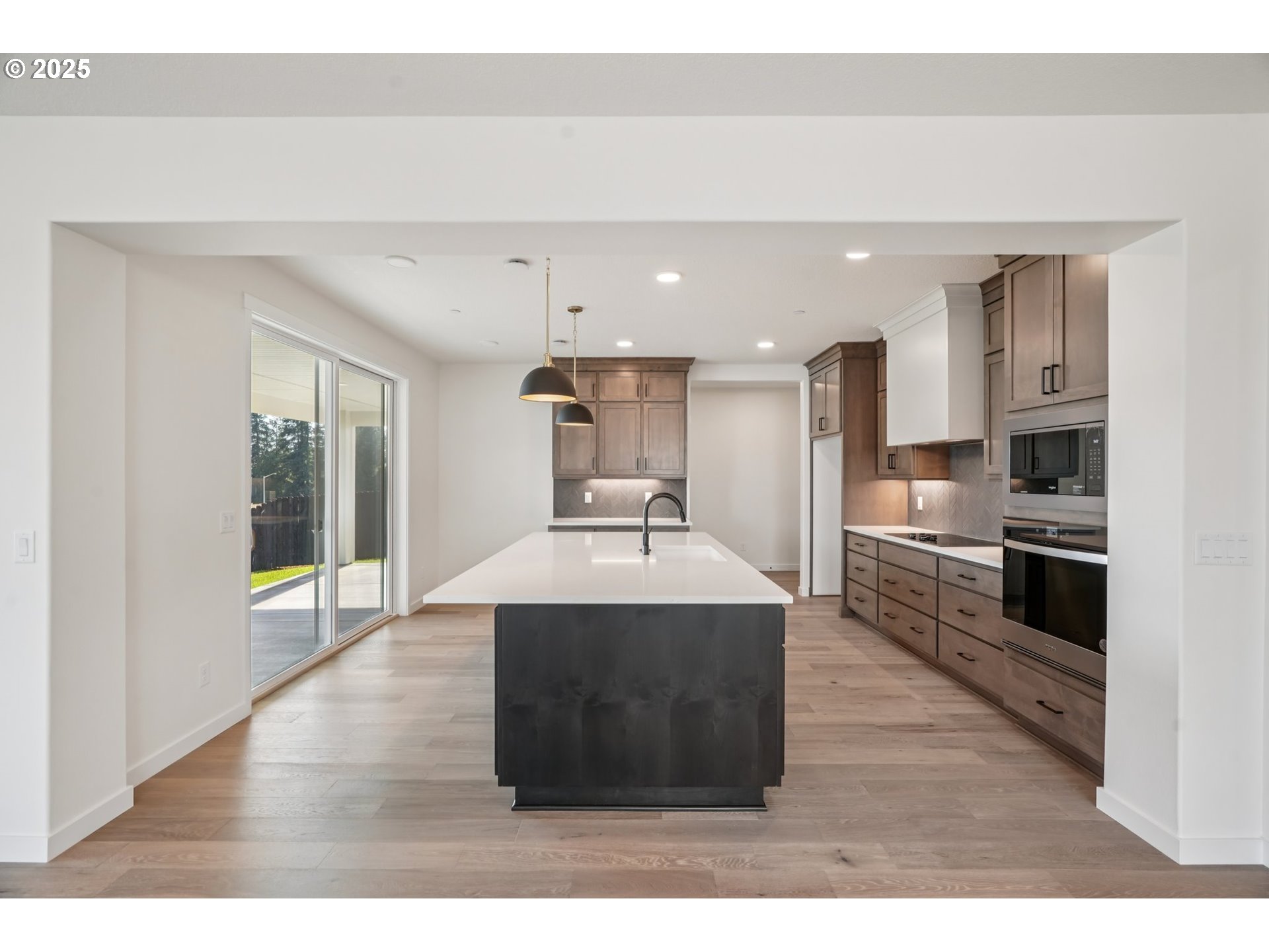 410 West 20th Way La Center, WA 98629 - Photo 13 of 43 a kitchen with kitchen island stainless steel appliances a sink stove and refrigerator