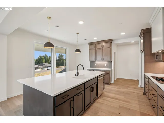 a kitchen with kitchen island a sink appliances and a counter top space