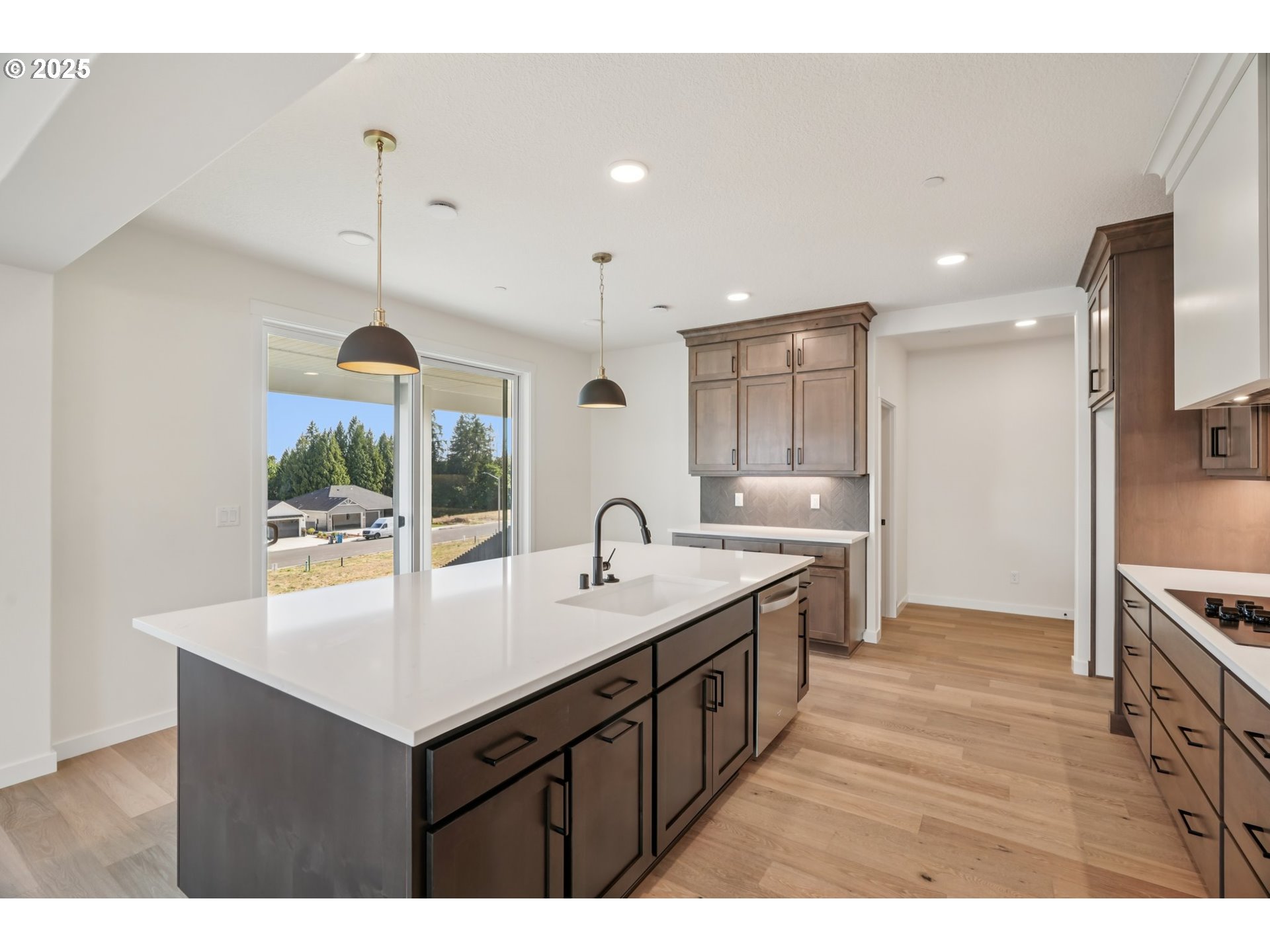 410 West 20th Way La Center, WA 98629 - Photo 14 of 43 a kitchen with kitchen island a sink appliances and a counter top space