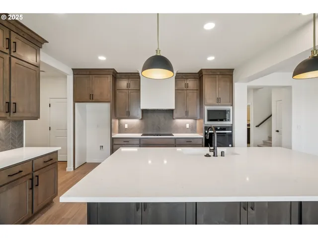a kitchen with a sink refrigerator and cabinets