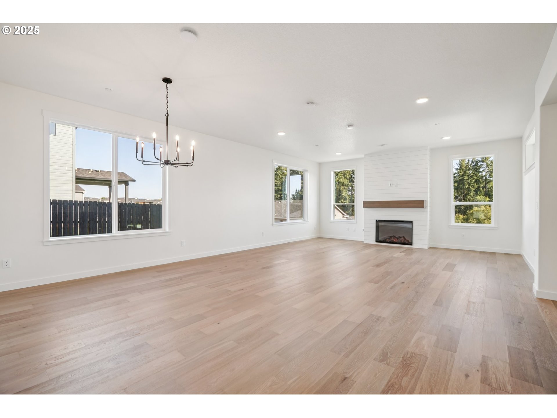 410 West 20th Way La Center, WA 98629 - Photo 6 of 43 a view of empty room with wooden floor and kitchen view