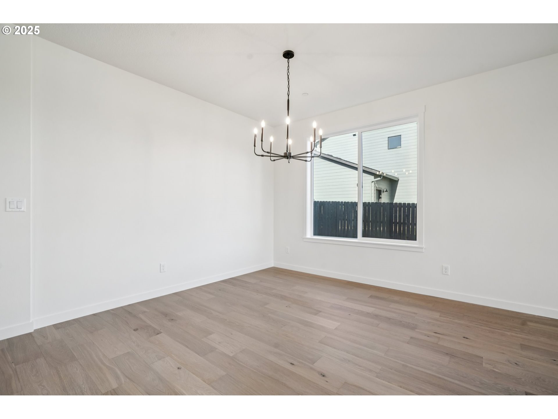 410 West 20th Way La Center, WA 98629 - Photo 7 of 43 a view of a room with wooden floor and chandelier