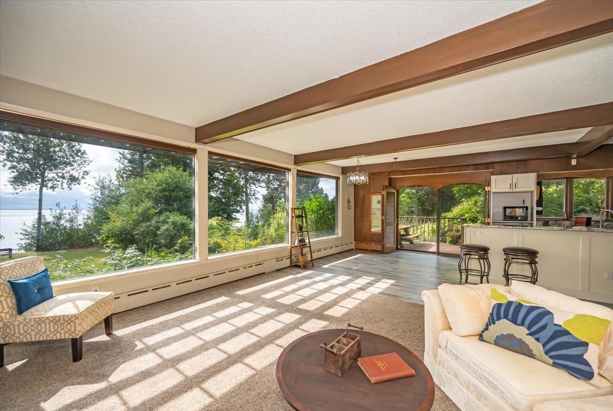 5130 London Road Duluth, MN 55804 - Photo 13 of 45 Sunroom / solarium with beamed ceiling, carpet flooring, a baseboard radiator, and a chandelier