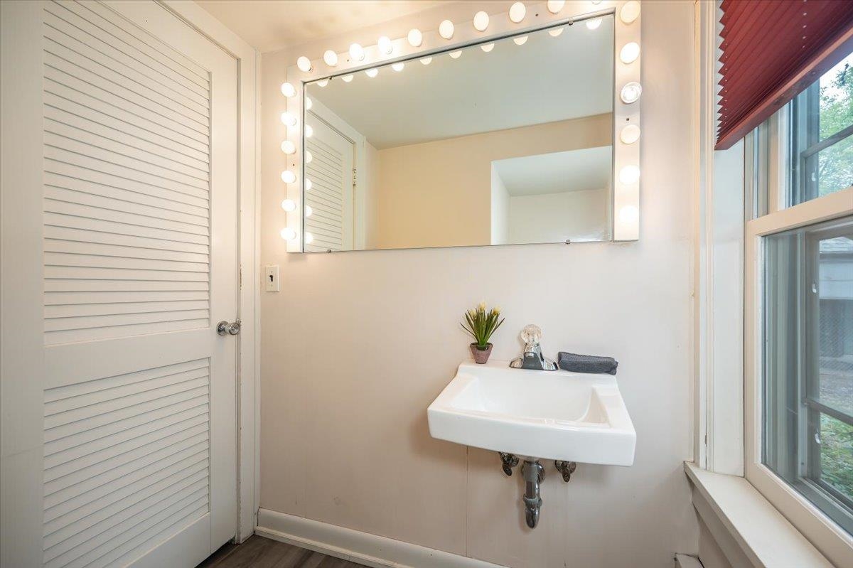 5130 London Road Duluth, MN 55804 - Photo 18 of 45 Bathroom featuring a sink and baseboards