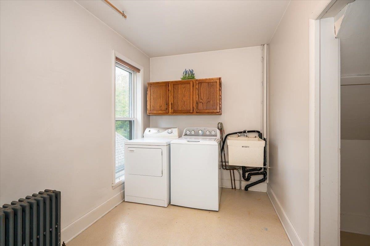 5130 London Road Duluth, MN 55804 - Photo 25 of 45 Laundry area featuring radiator, cabinet space, and washing machine and clothes dryer