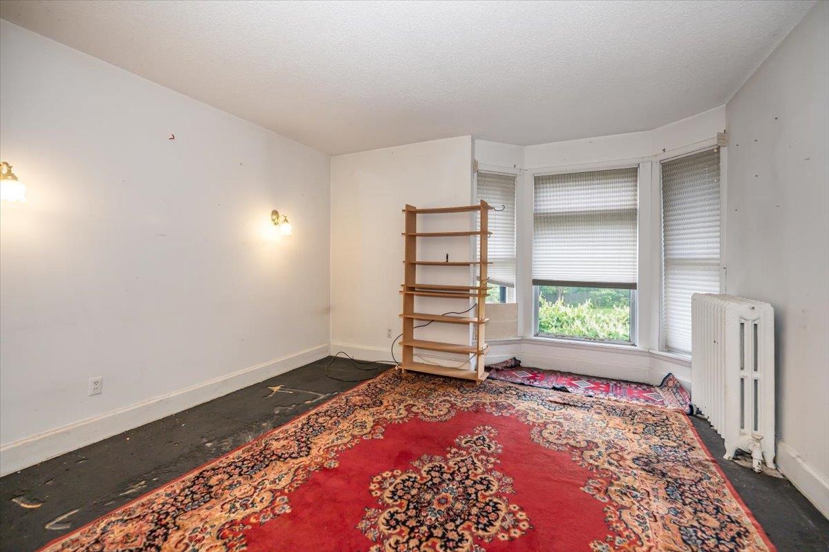 5130 London Road Duluth, MN 55804 - Photo 27 of 45 Unfurnished bedroom featuring radiator heating unit and a textured ceiling