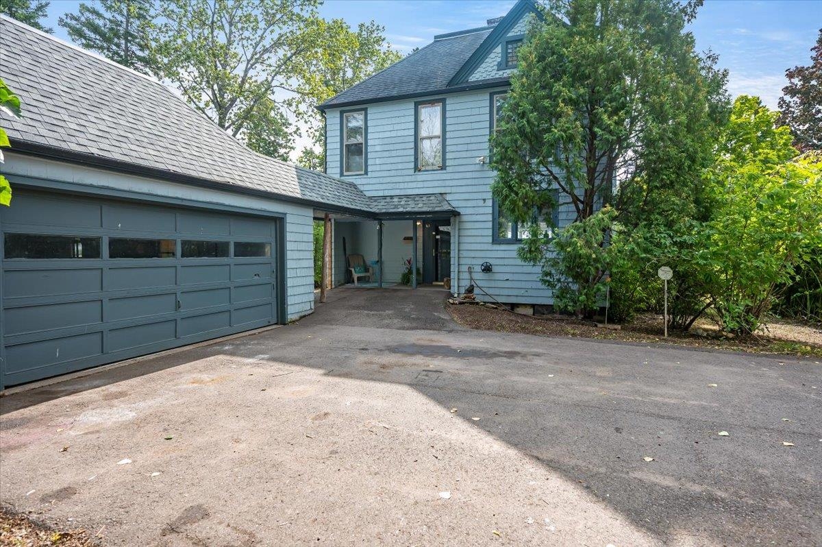 5130 London Road Duluth, MN 55804 - Photo 3 of 45 View of front facade with driveway, roof with shingles, and a garage