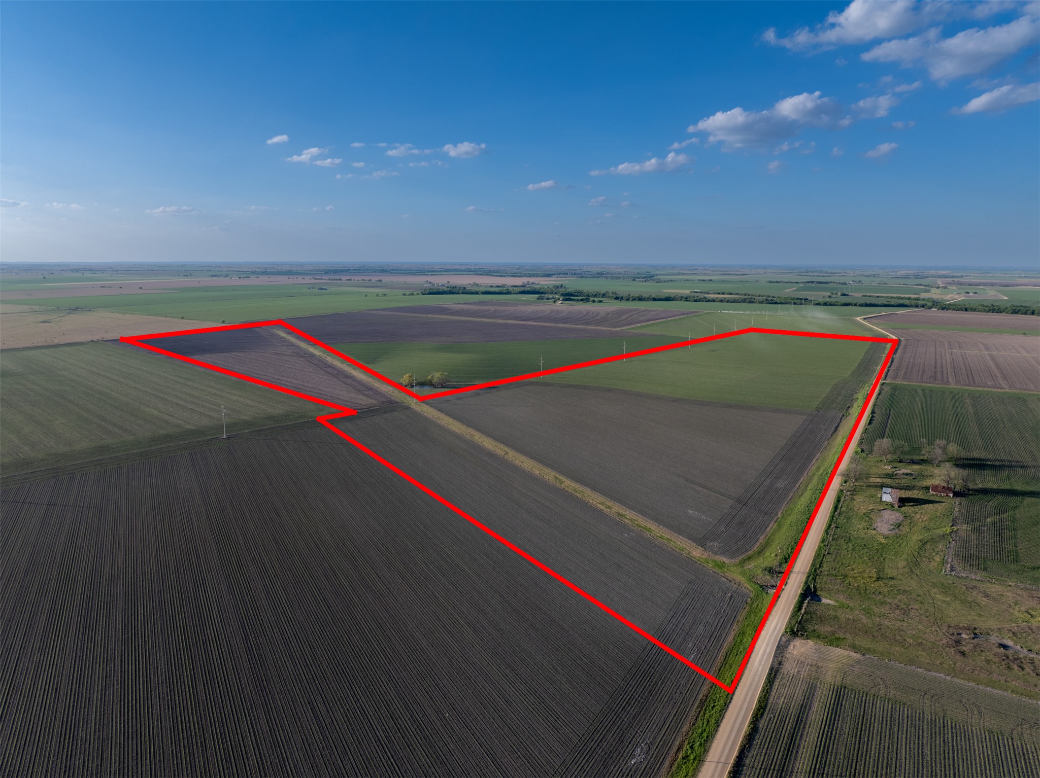 Overview of rural landscape with property boundaries highlighted and large plots for crops