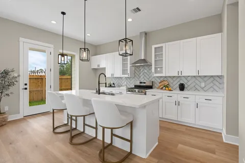 a kitchen with a table chairs refrigerator and microwave