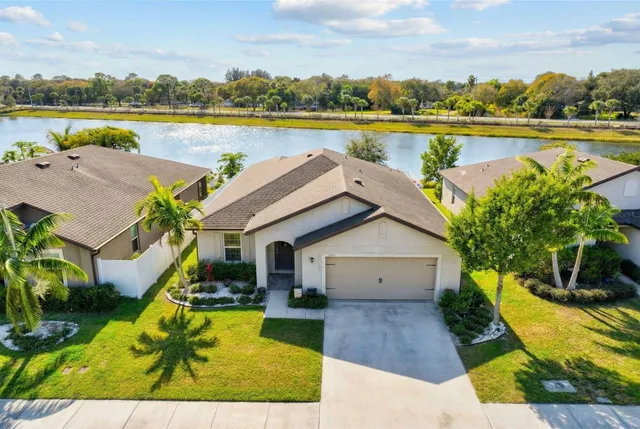a view of a house with a swimming pool and a yard