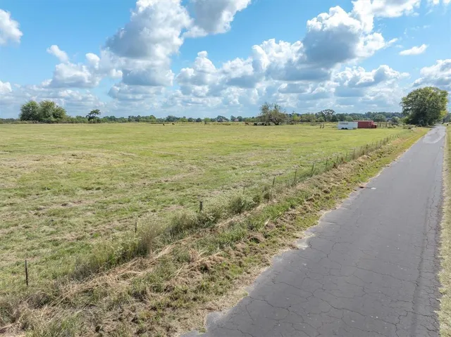 a view of a field with an ocean