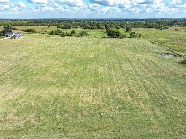 a view of a field with an ocean