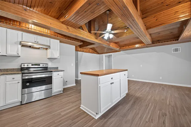 a kitchen with wooden floors and white appliances