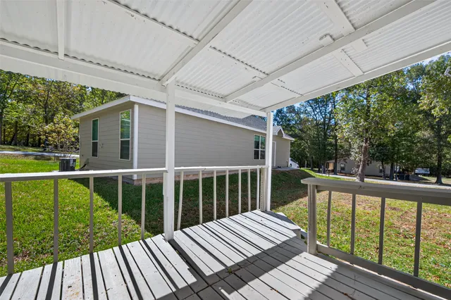 a view of balcony with wooden floor and fence