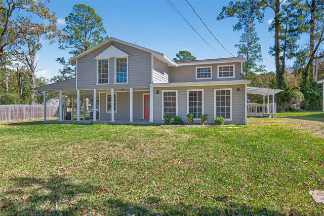a view of a house with a backyard