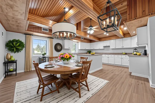 a dining room with a wooden table and chairs