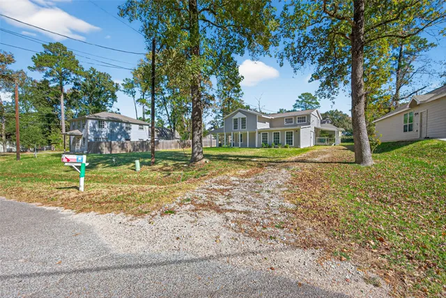 a view of a house with a yard and plants