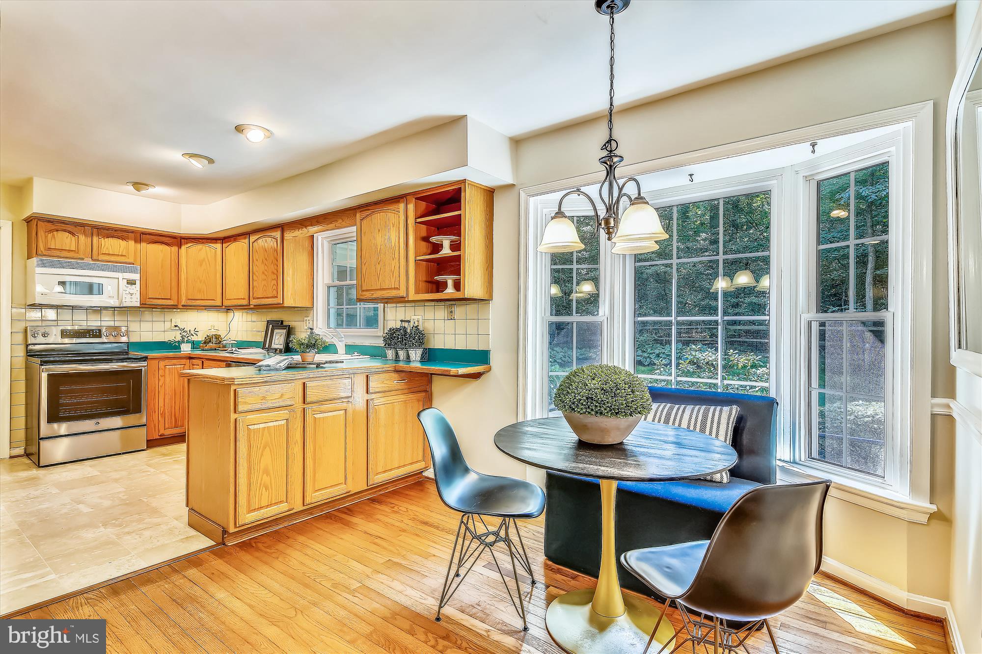 11407 Drop Forge Lane Reston, VA 20191 - Photo 9 of 48 a kitchen with stainless steel appliances granite countertop a dining table chairs and granite counter tops