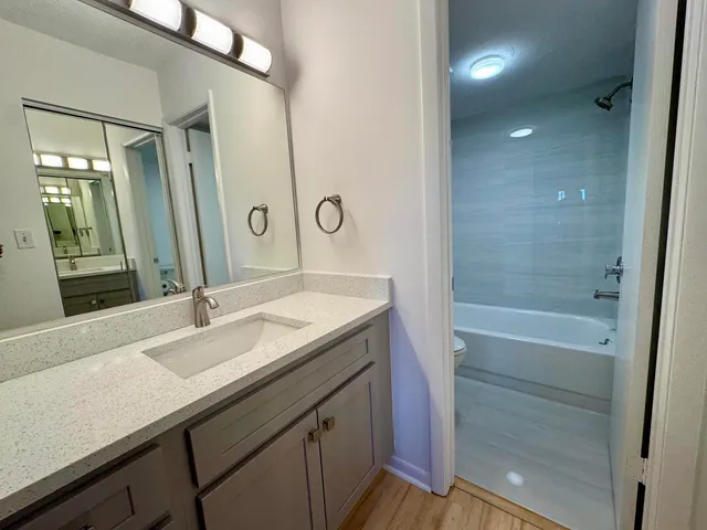 a white bath tub sitting next to a toilet