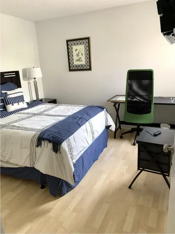 a bedroom with a bed and dresser