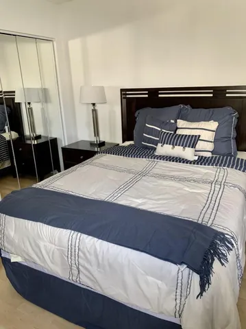 a bathroom with a bathtub a sink a toilet and a mirror