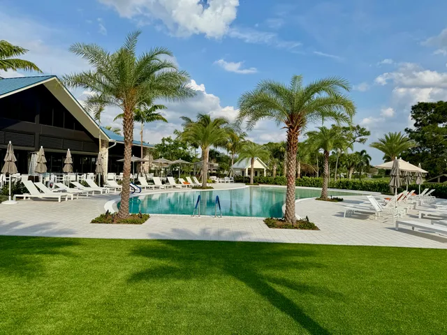 a view of swimming pool with outdoor seating and lake view
