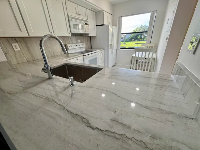 a bedroom with a bed and a lamp