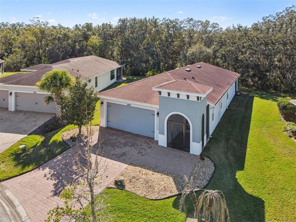 a aerial view of a house with swimming pool yard and mountain view in back